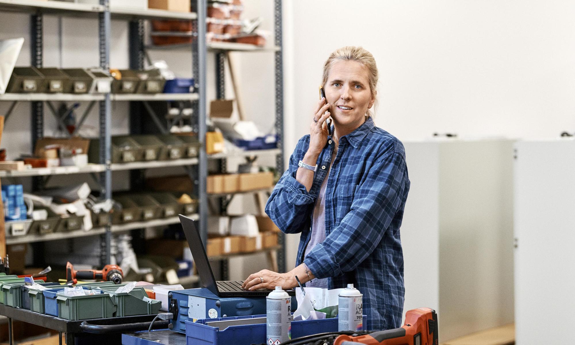 Woman in factory talking in phone