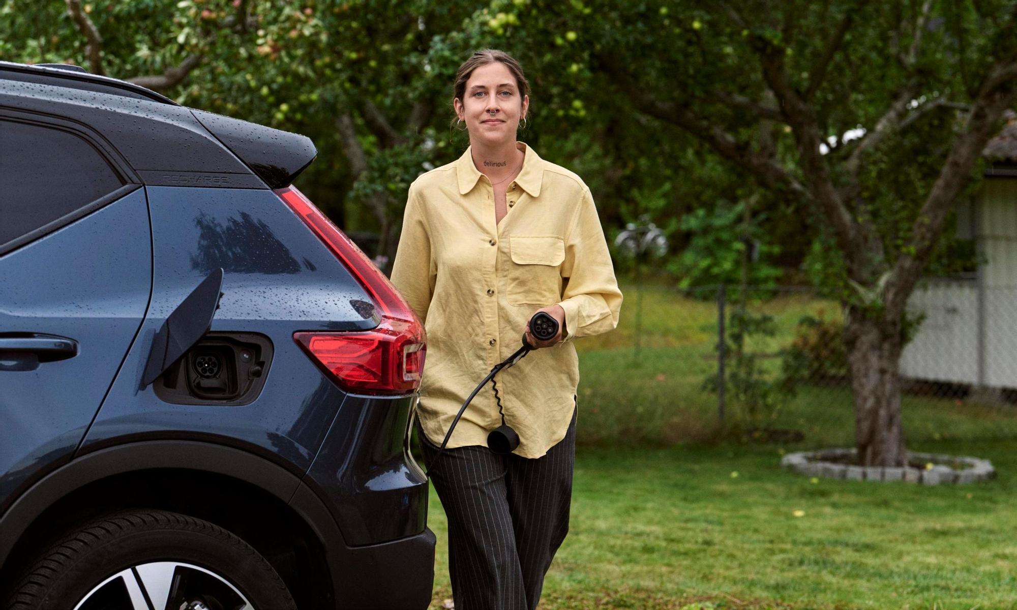 Woman charging electric car