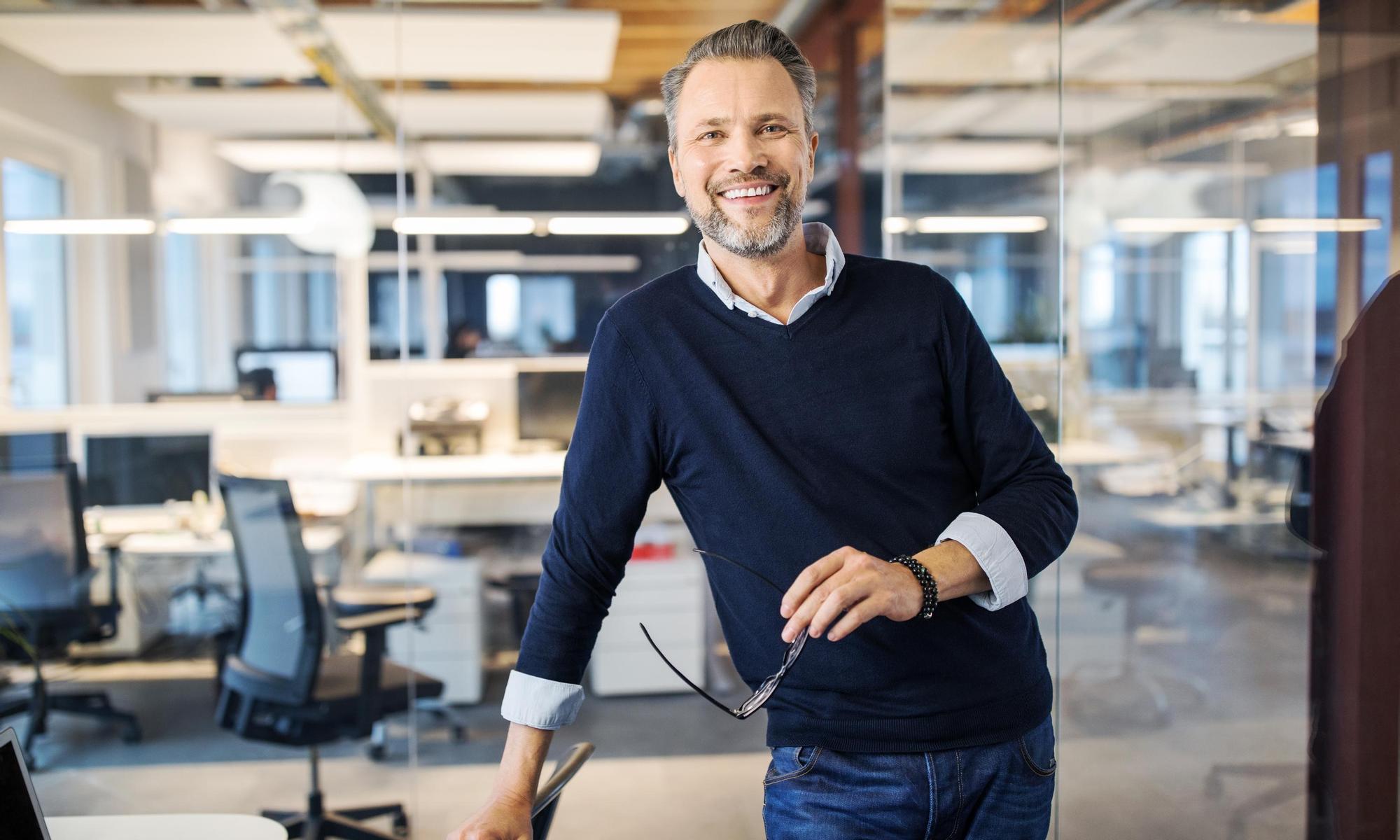 Mid adult businessman standing in office