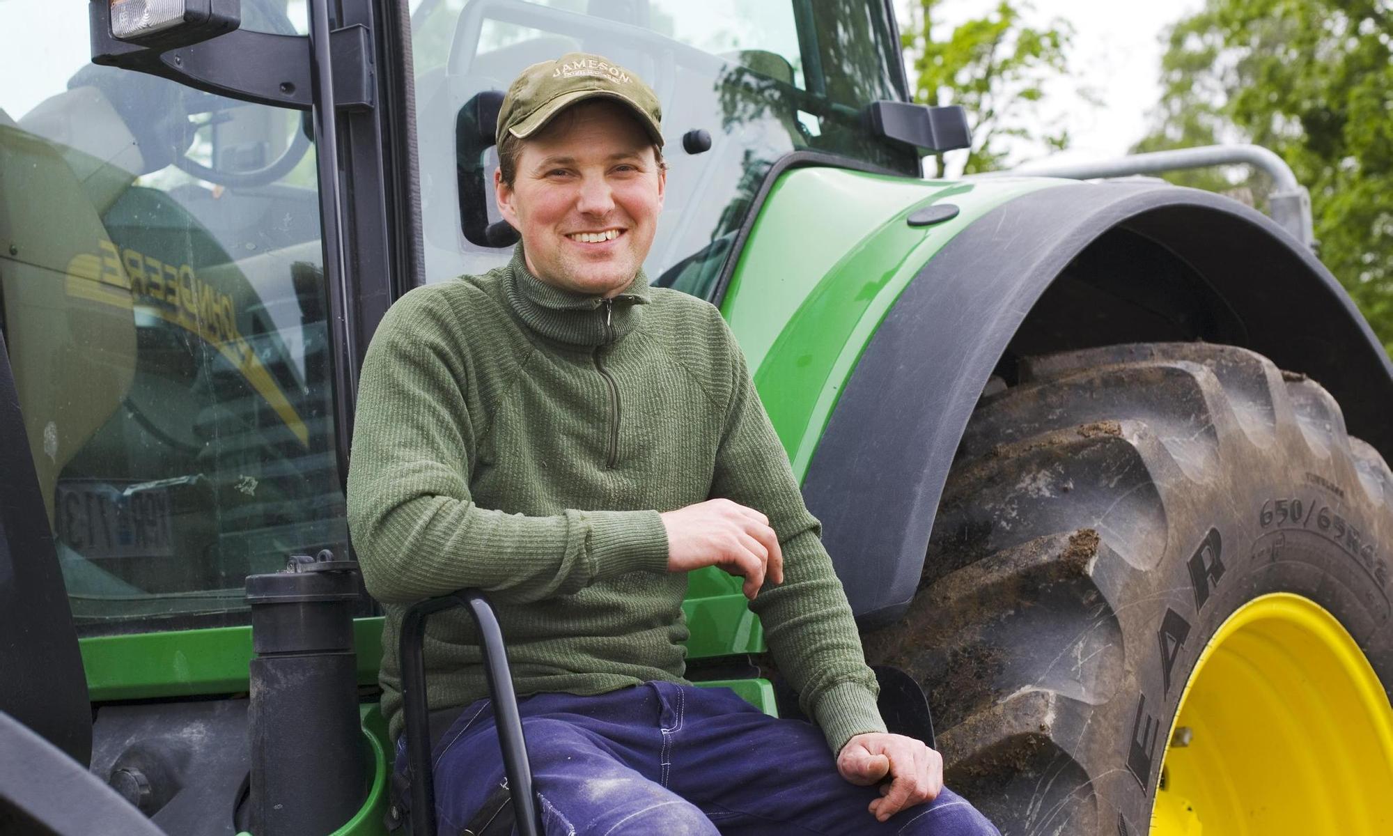 A farmer by his tractor